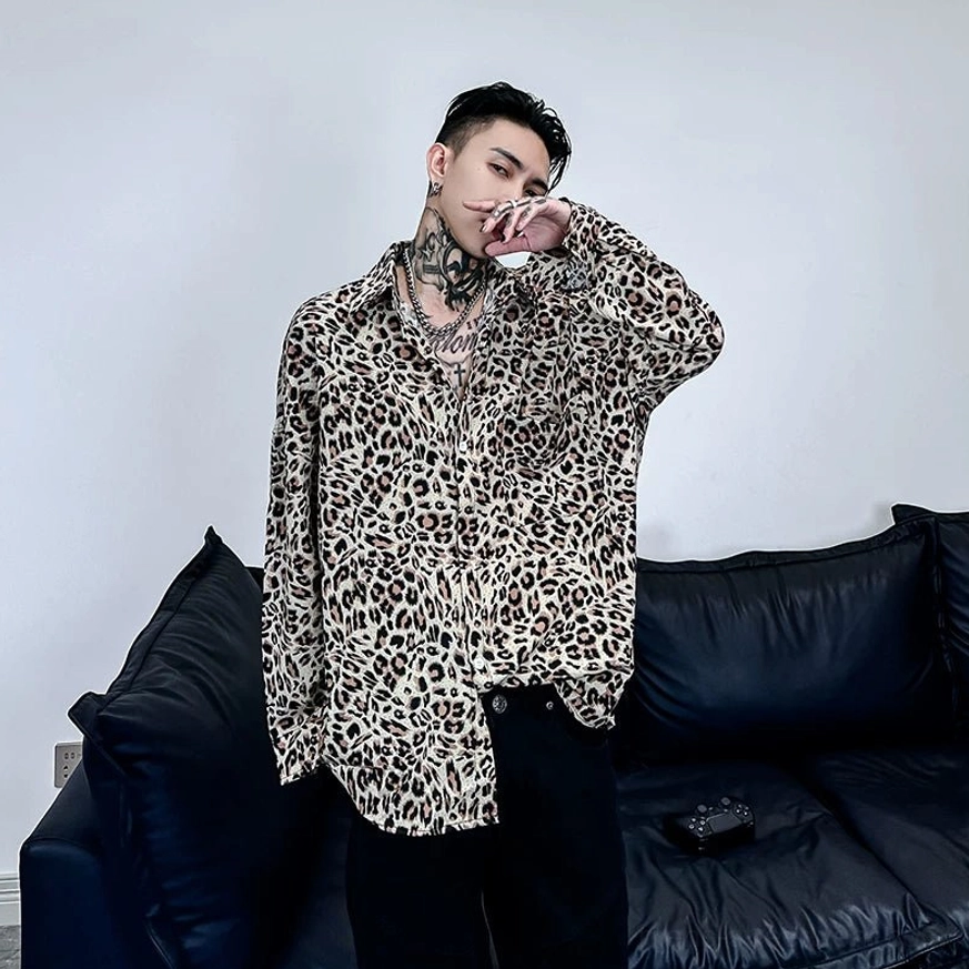 Three-quarter front view of a relaxed leopard print satin shirt featuring a chest pocket asymmetric hem and smooth satin finish