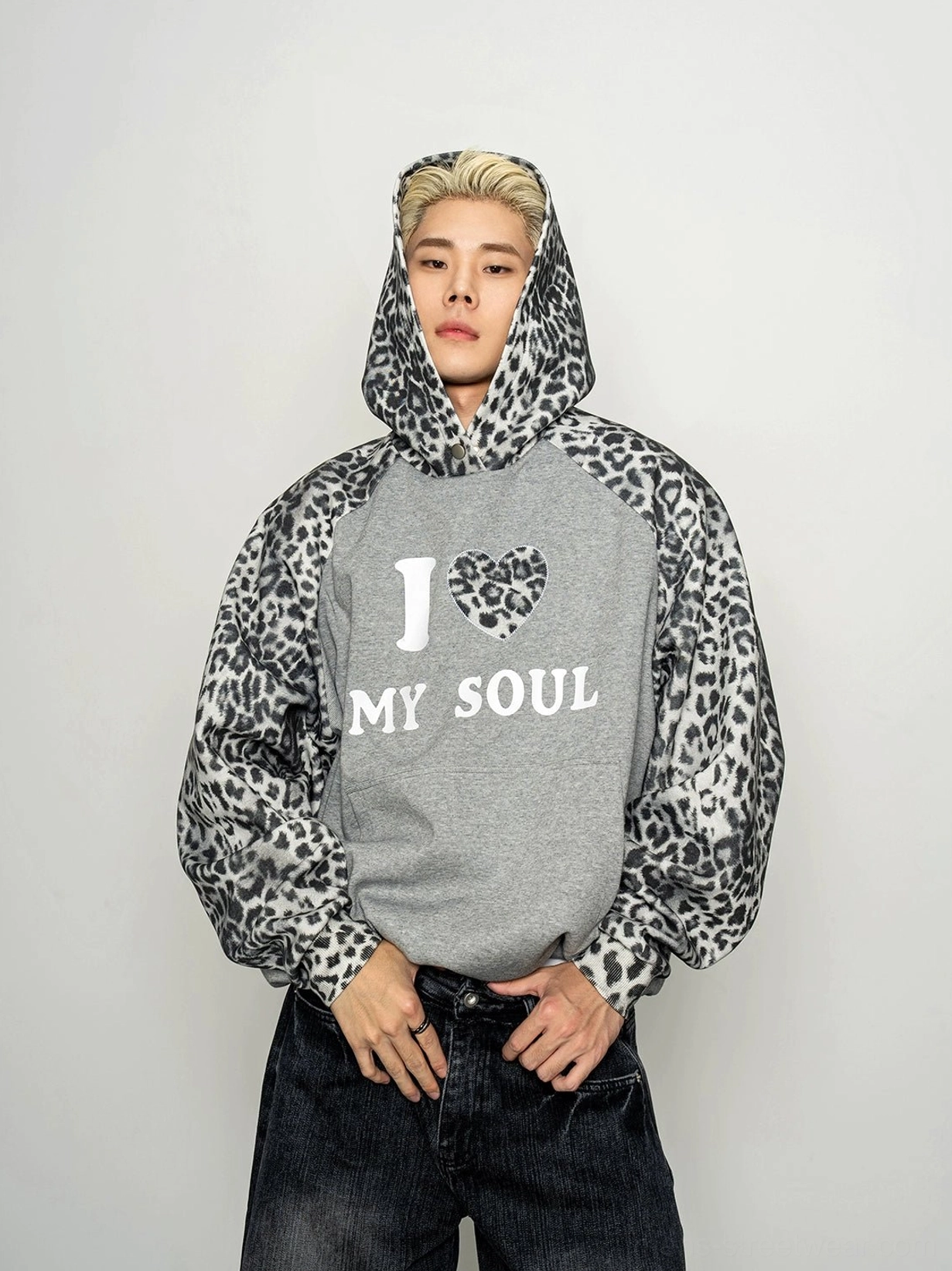 Front half-body view of relaxed oversized grey hoodie with leopard print raglan sleeves and hood plus I Love My Soul chest graphic