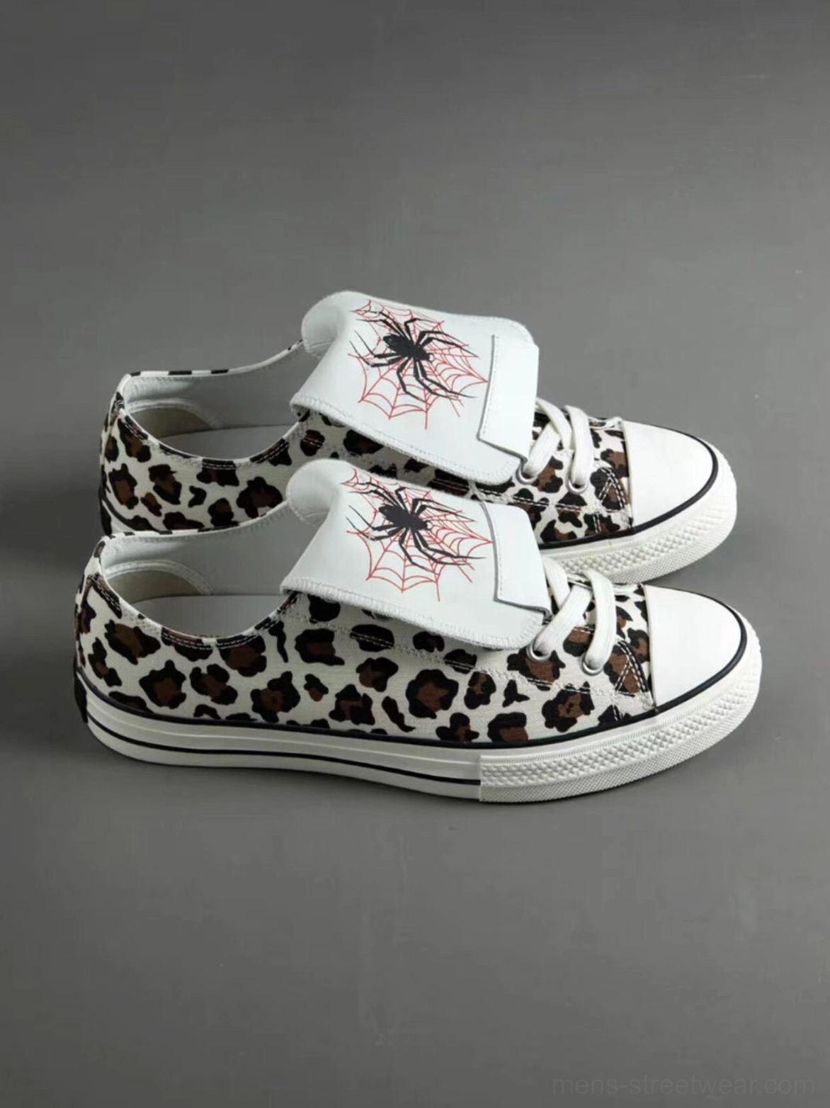 Alternative streetwear leopard canvas sneakers with graphic spider tongue, contrast laces, rounded rubber toe, and flat outsole