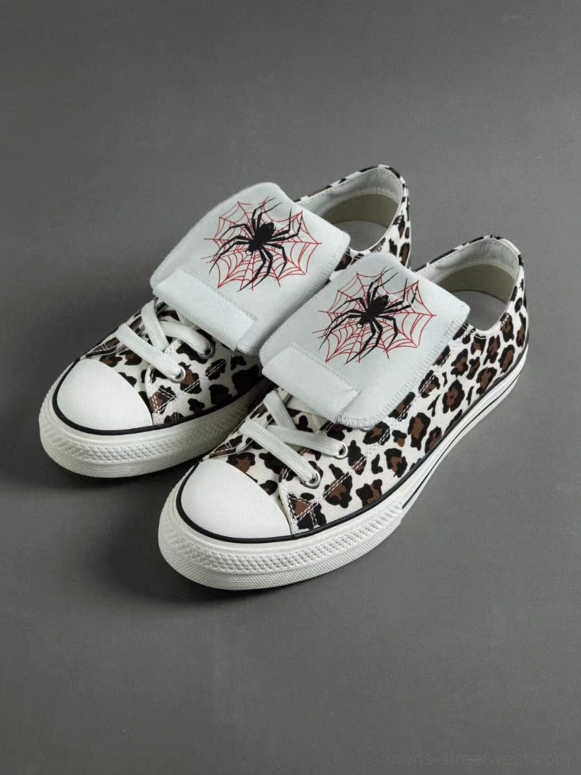 Top-down view of leopard print spider-tongue sneakers with red and black embroidery, replacement laces, and detachable tongue straps