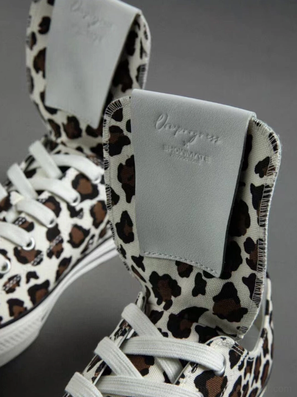 Detailed leopard print canvas streetwear sneakers with foldable spider embroidered tongue, lace-up fastening, rubber toe cap, and flat sole