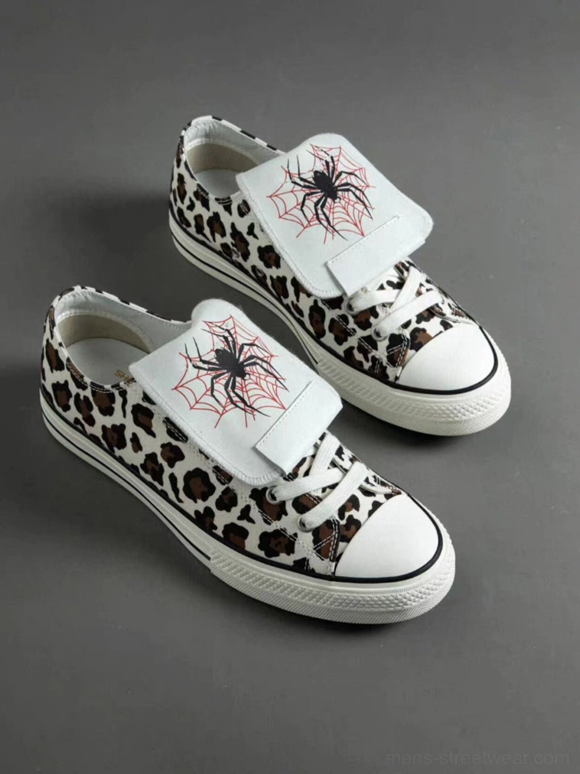 Leopard spider-tongue canvas sneaker colorway with animal print upper, embroidered tongue detail, white rubber sole, and contrast laces