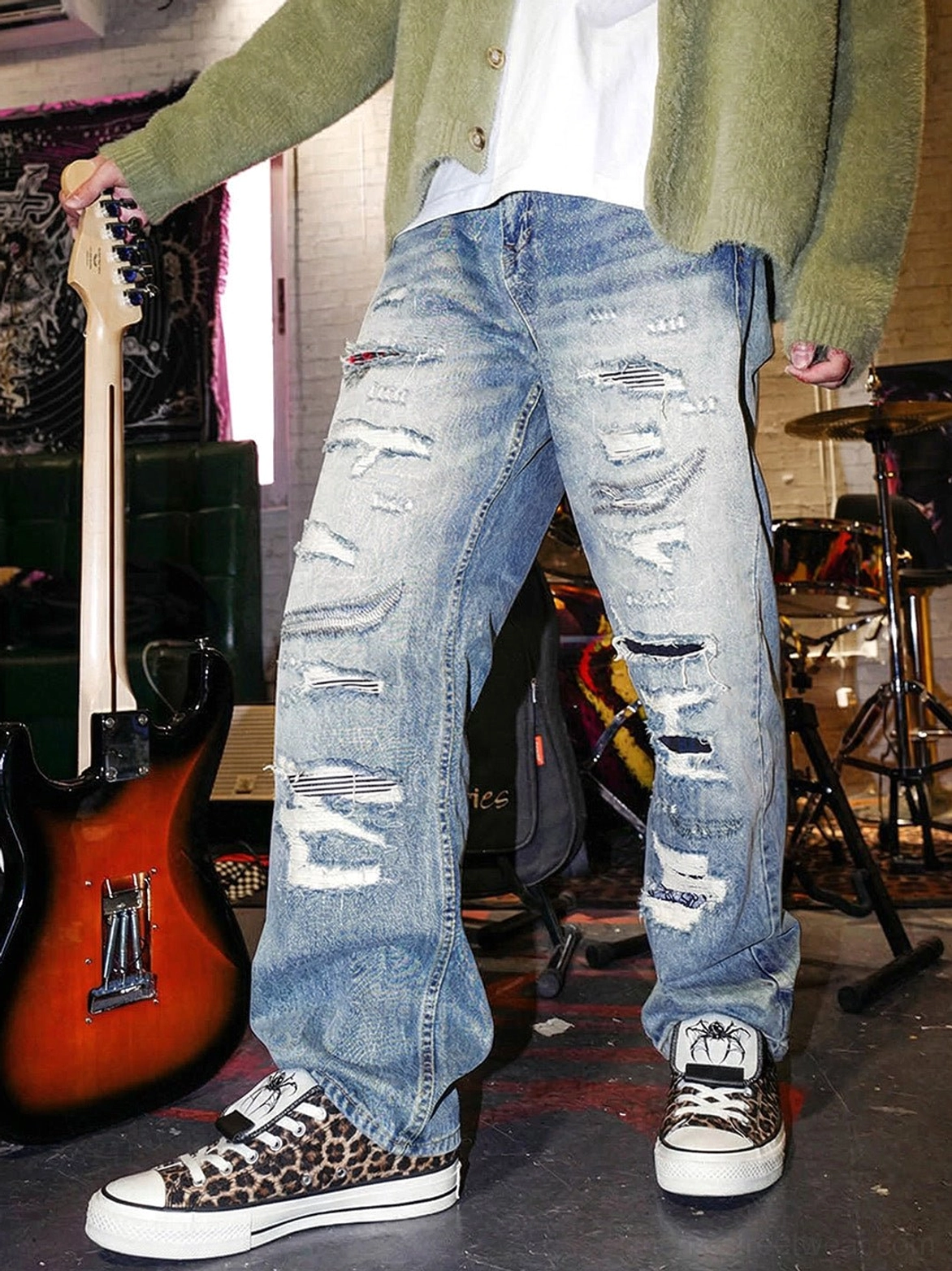 Leopard print canvas sneakers styled with ripped jeans in a band rehearsal studio, creating a Korean punk and alternative streetwear outfit