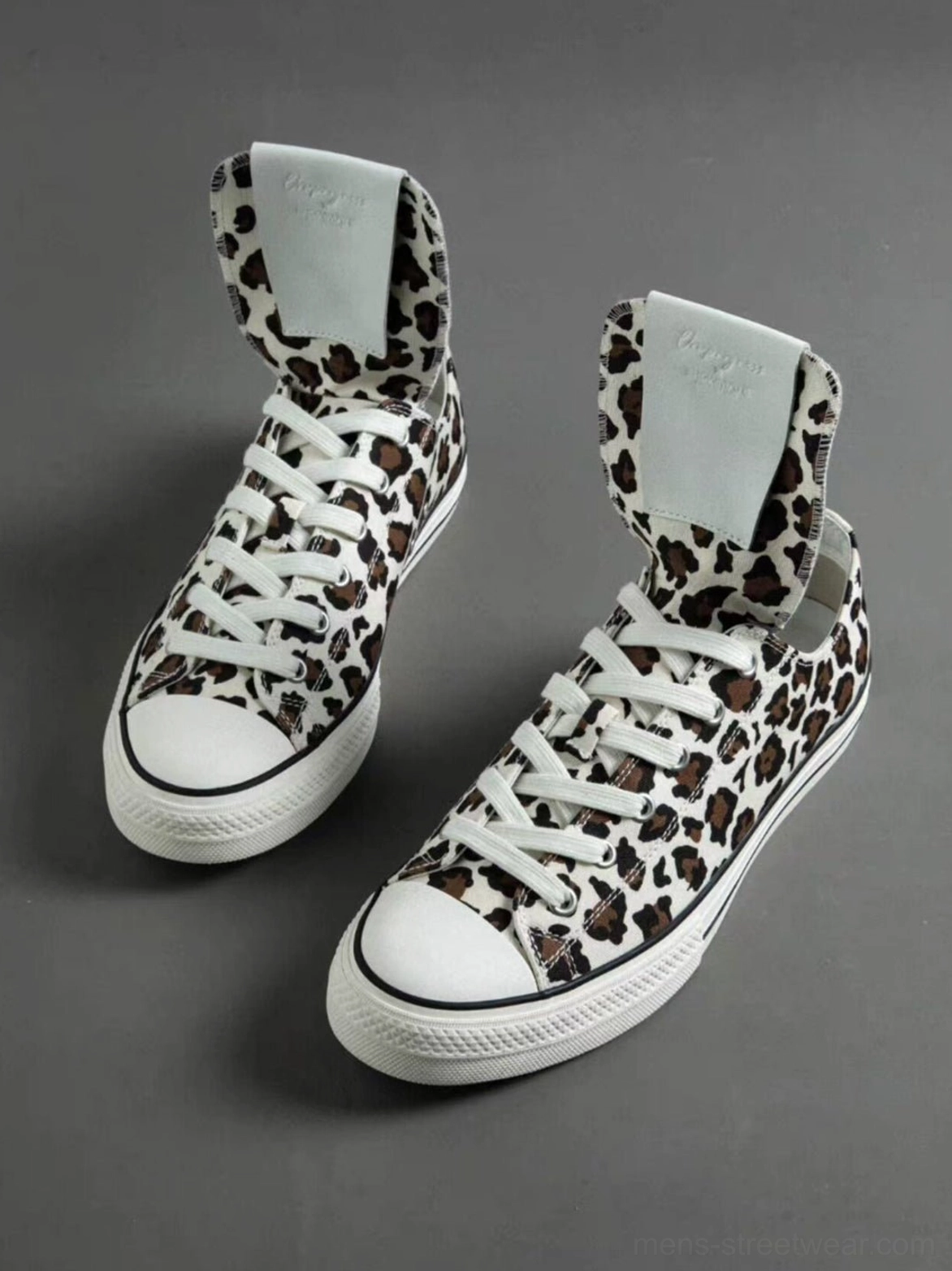 Statement leopard spider-tongue sneakers with textured canvas upper, lace-up front, white toe cap, and everyday rubber outsole