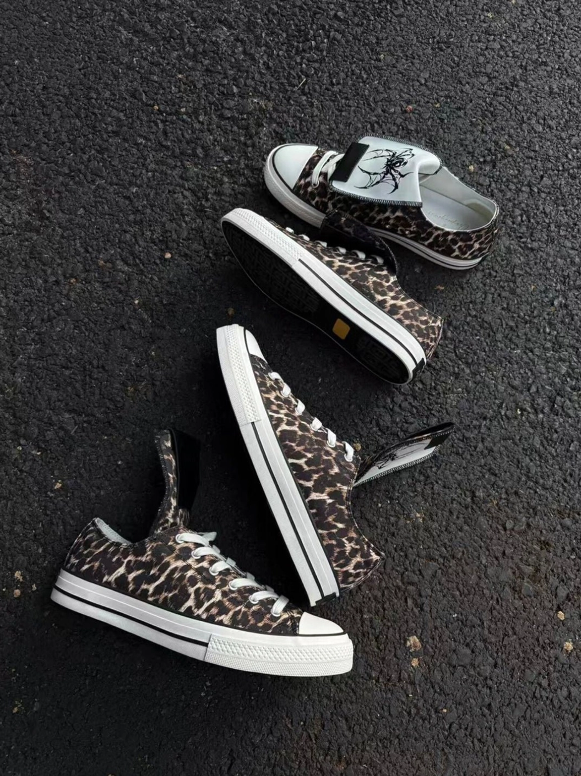 Leopard print spider-tongue canvas sneakers displayed for alternative Korean streetwear styling with contrasting rubber toe caps and flat soles