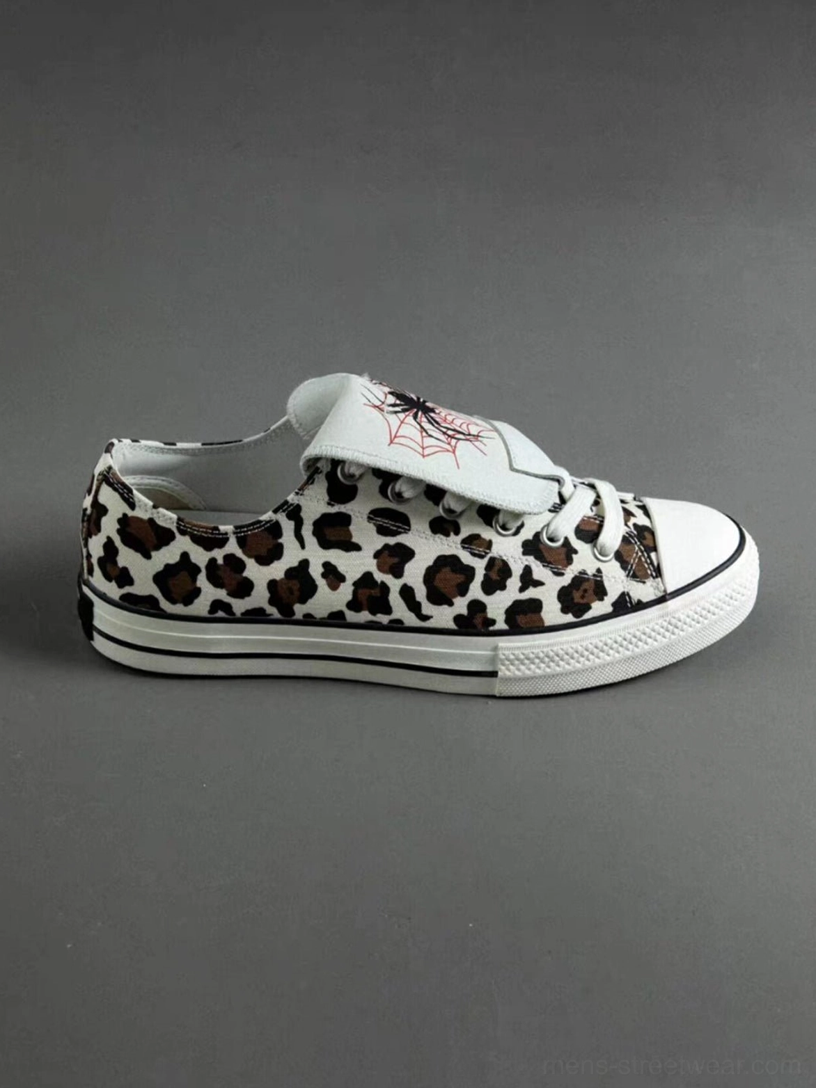Unisex leopard spider-tongue canvas shoes showcasing contrast embroidery, textured animal print fabric, and classic rubber sneaker details