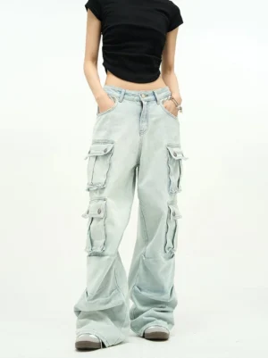 Front view of light blue baggy cargo jeans featuring a high-rise waistband, zip fly, relaxed wide-leg fit, and symmetrical thigh flap pockets