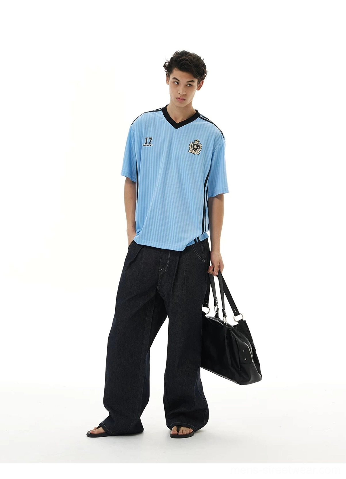 Light blue crested soccer jersey tee with vertical pinstripes, V-neckline, number 17 graphic, and dark wide-leg jeans