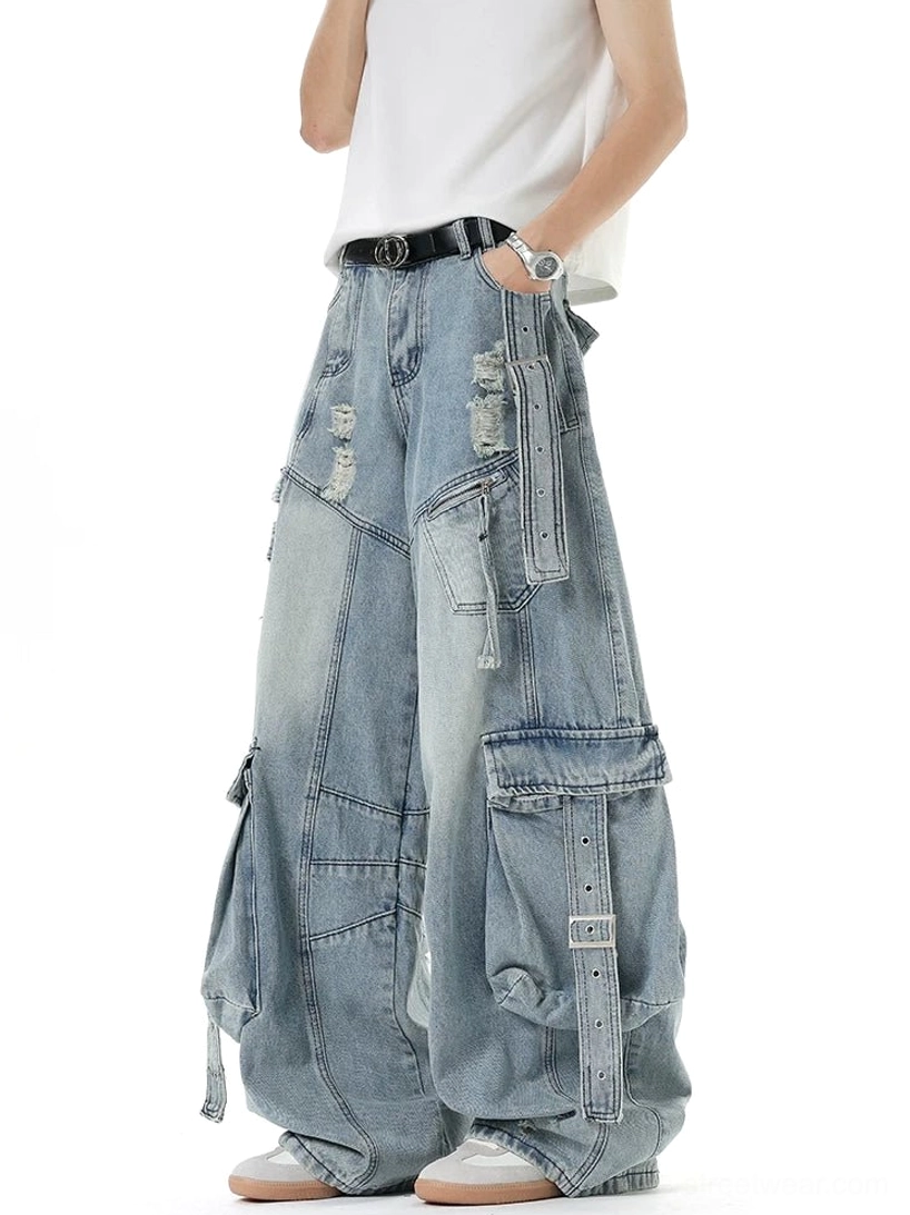 Side view of light blue distressed cargo denim pants with wide-leg silhouette, detailed strap pockets, and oversized Y2K streetwear shape
