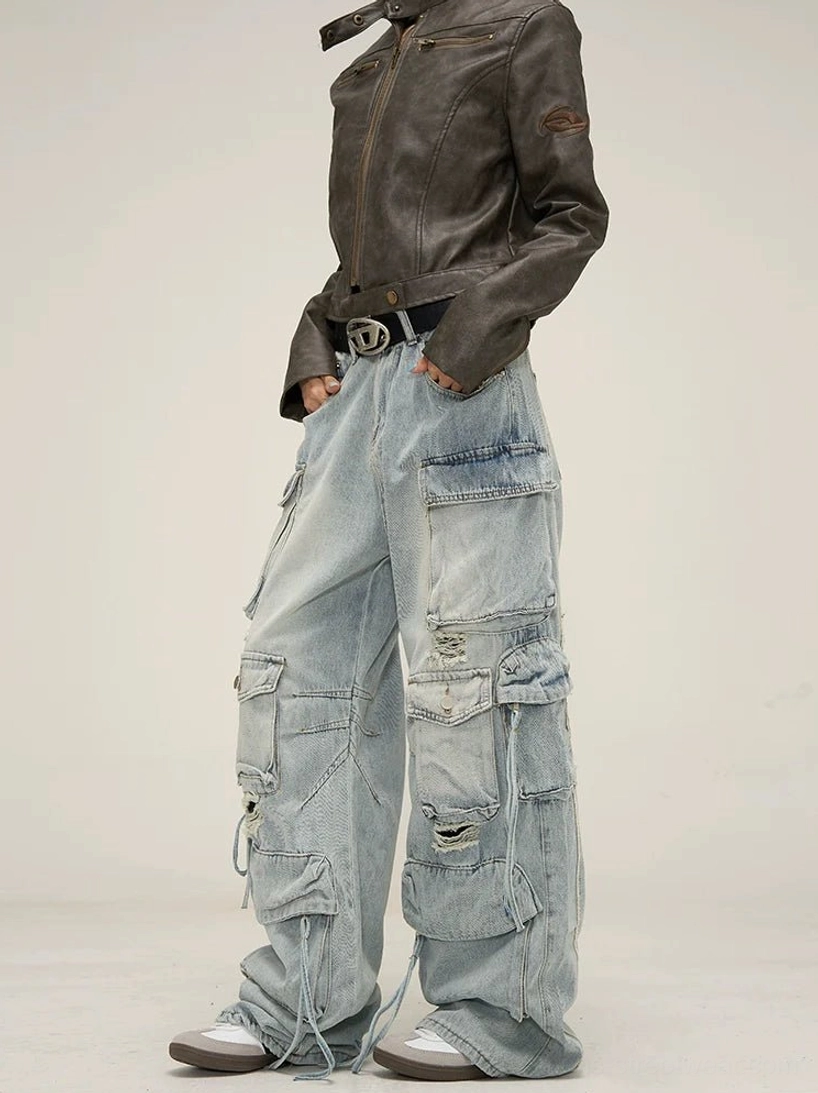 Light blue distressed wide-leg cargo jeans three-quarter front view with multi flap cargo pockets, ripped details, washed denim, and adjustable cuffs