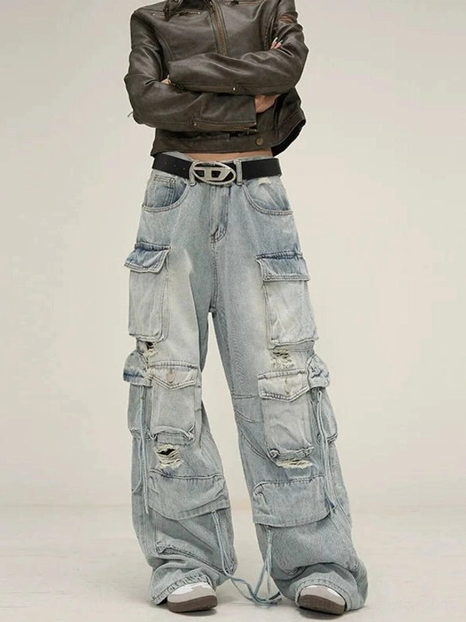 Light blue distressed wide-leg cargo jeans front low-angle view with flap pockets, ripped denim details, drawstring hems, and oversized streetwear fit