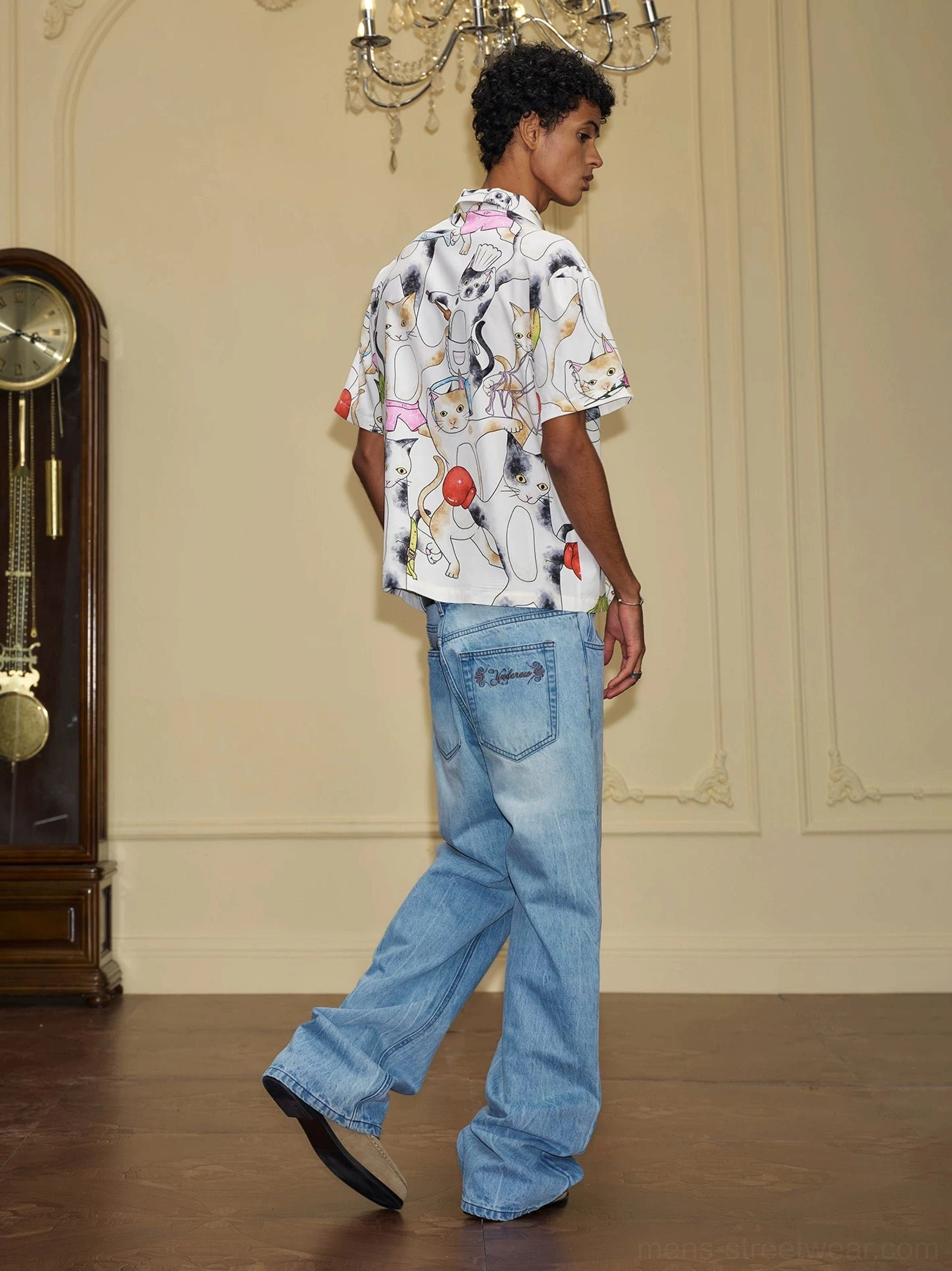 Light blue faded asymmetric waist wide-leg jeans rear three-quarter view showing classic back pockets