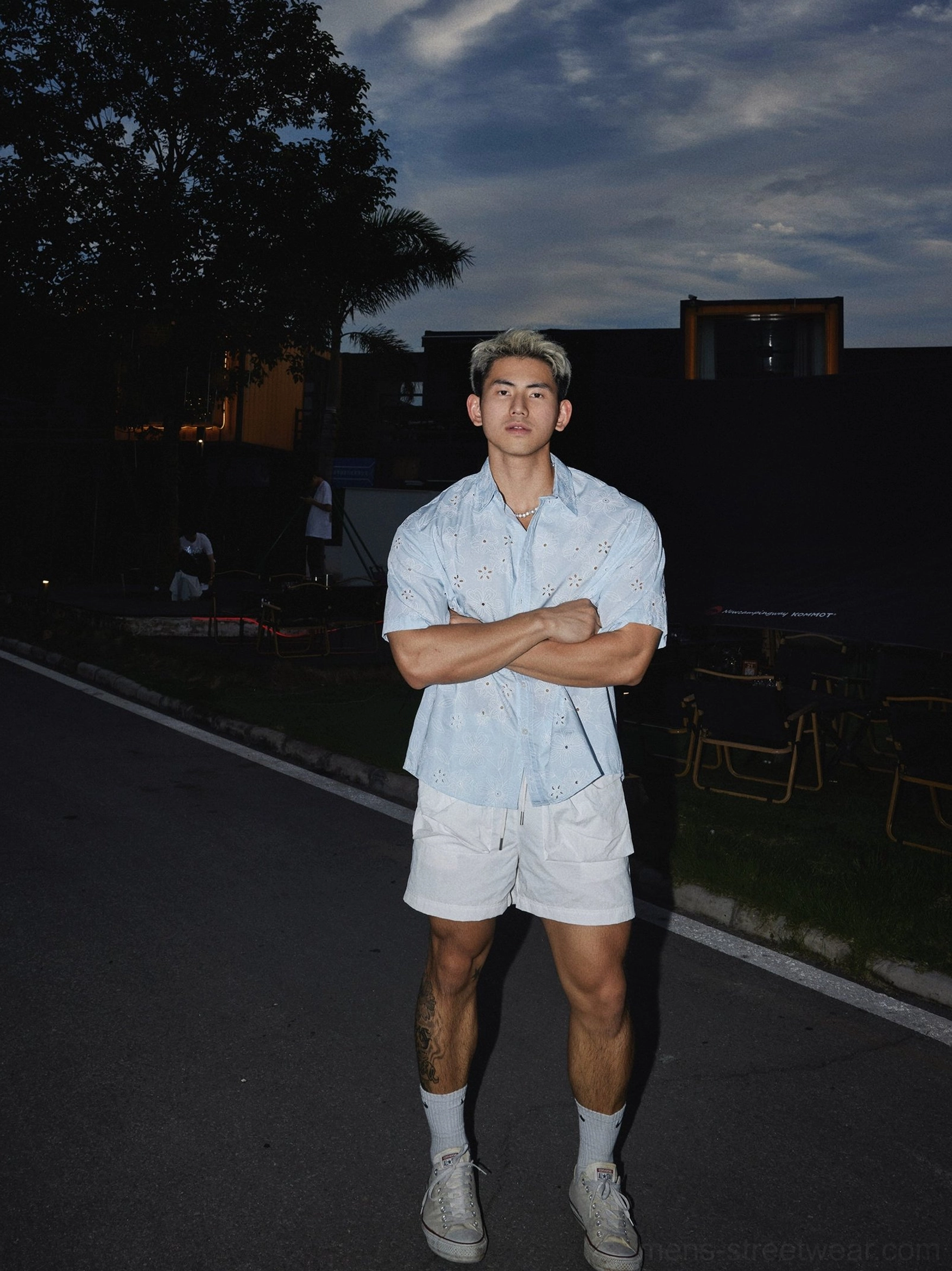 Light blue floral eyelet short sleeve shirt styled with white shorts and sneakers for casual summer streetwear
