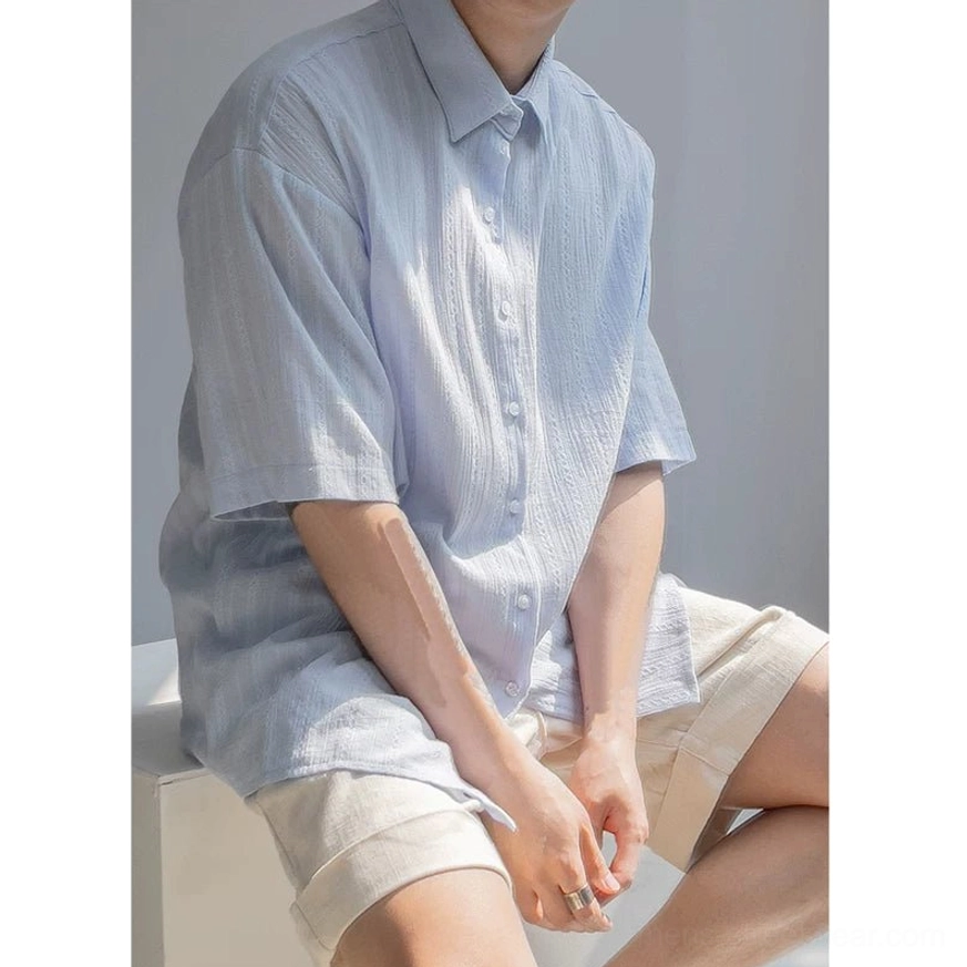 Light blue men's relaxed textured stripe shirt with button front and dropped shoulder fit shown from three quarter view