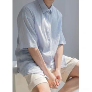 Light blue men's textured stripe short sleeve shirt in relaxed Korean streetwear fit with dropped shoulders and khaki shorts