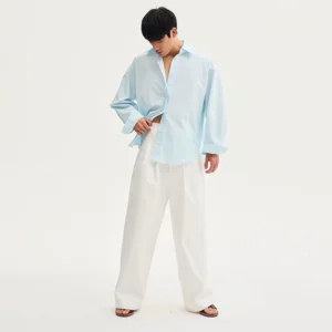 Light blue oversized cotton poplin drop-shoulder streetwear shirt shown in a full body side view