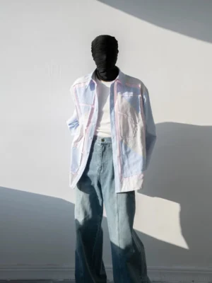 Light blue oversized pinstripe patchwork shirt with pink piping and geometric chest panels front outfit view