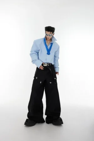 Light blue oversized shoulder pad tie-neck shirt full front view styled with black wide-leg cargo pants and silver sunglasses