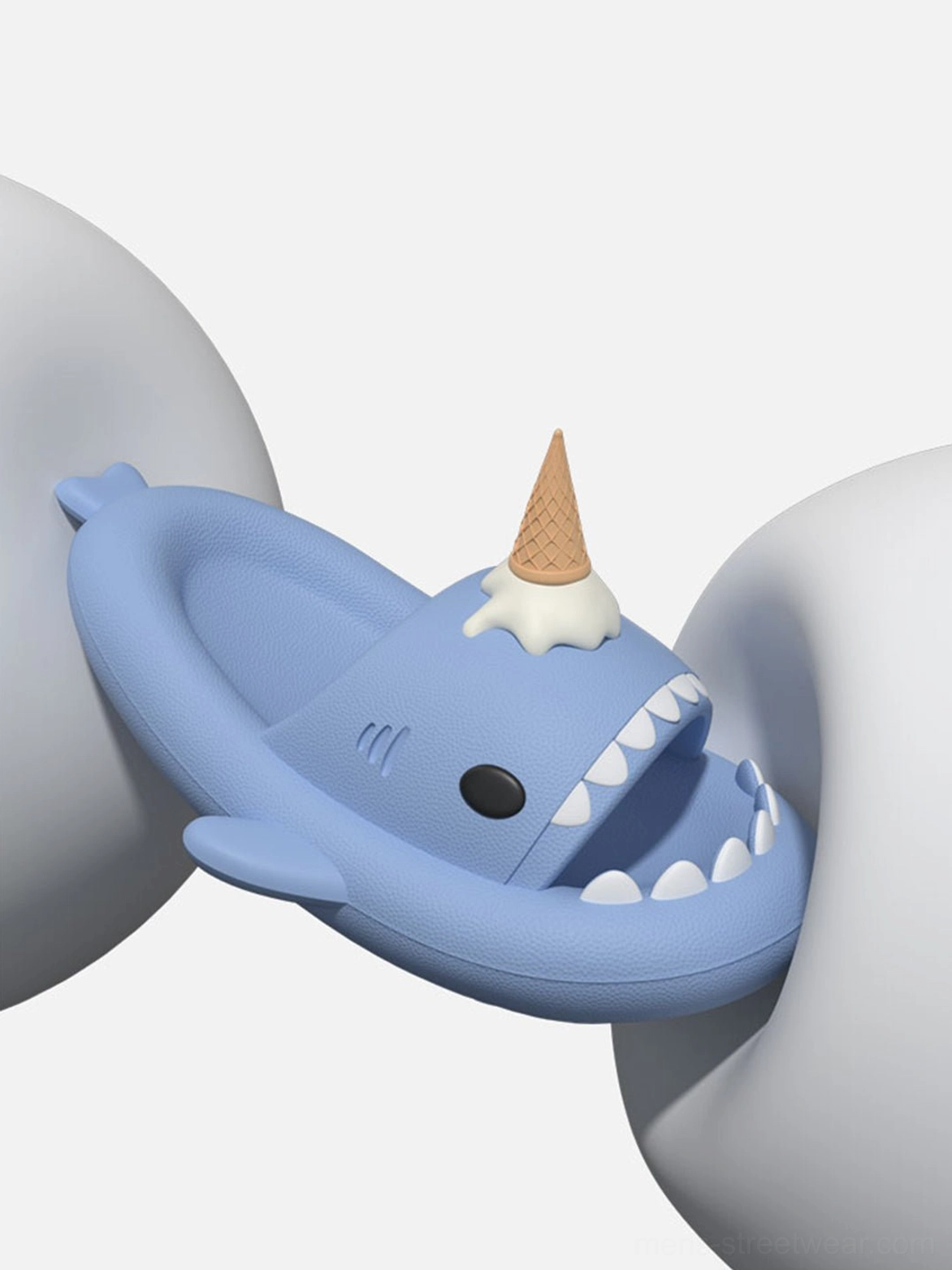 Close-up light blue shark slide slipper showing sharp white teeth, sculpted open mouth, and ice cream ornament