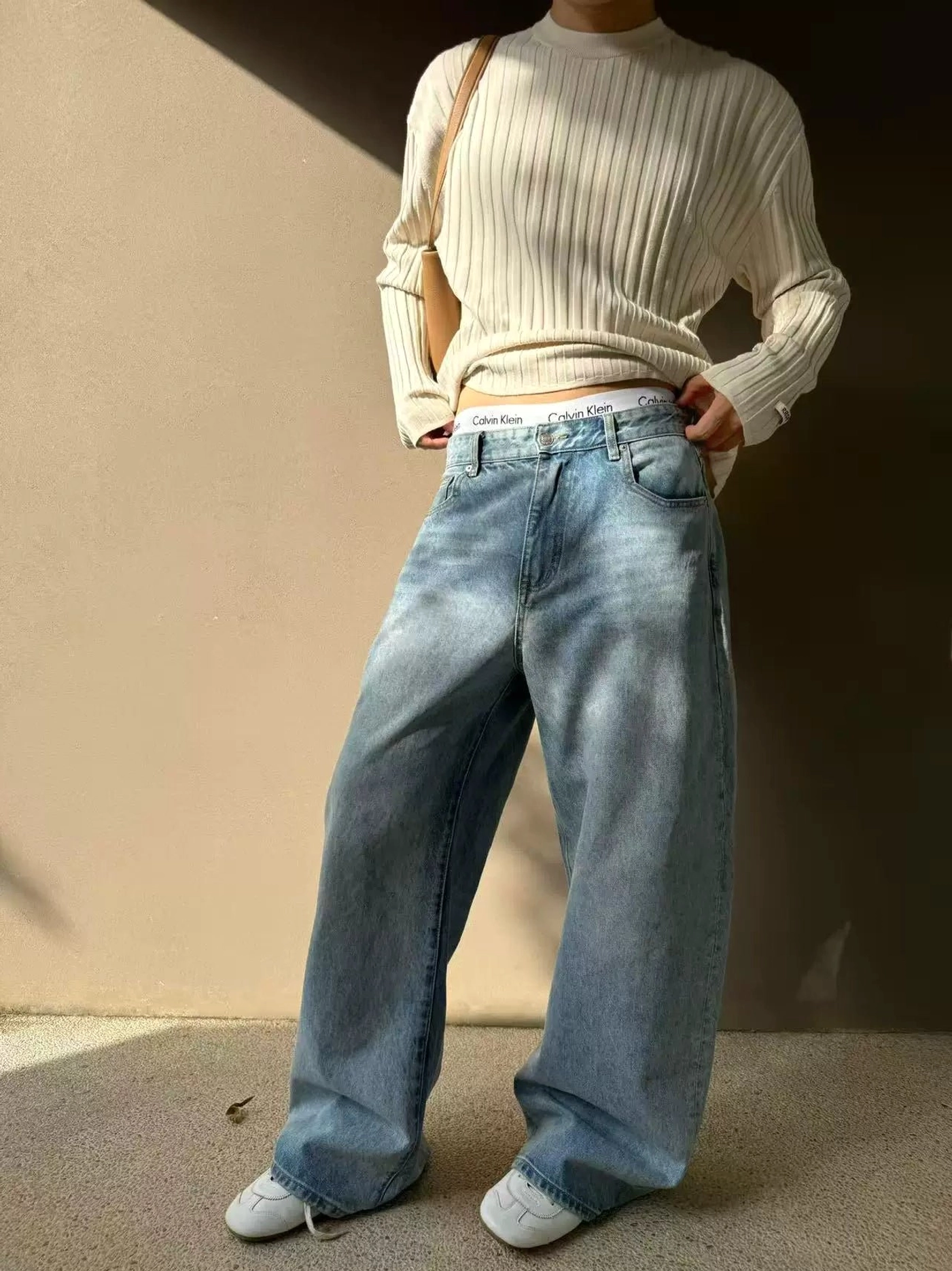 Men's light blue sun-faded wide leg denim jeans with a relaxed full-length silhouette and classic five-pocket construction