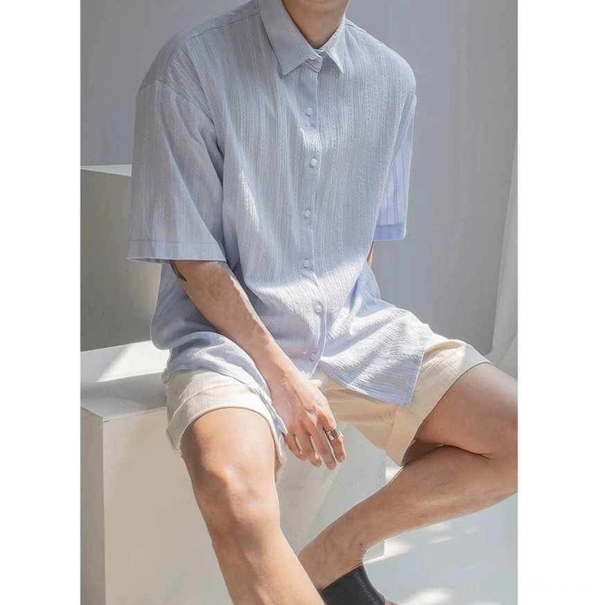 Front view of light blue men's textured stripe button up shirt with vertical textured stripes and boxy fit