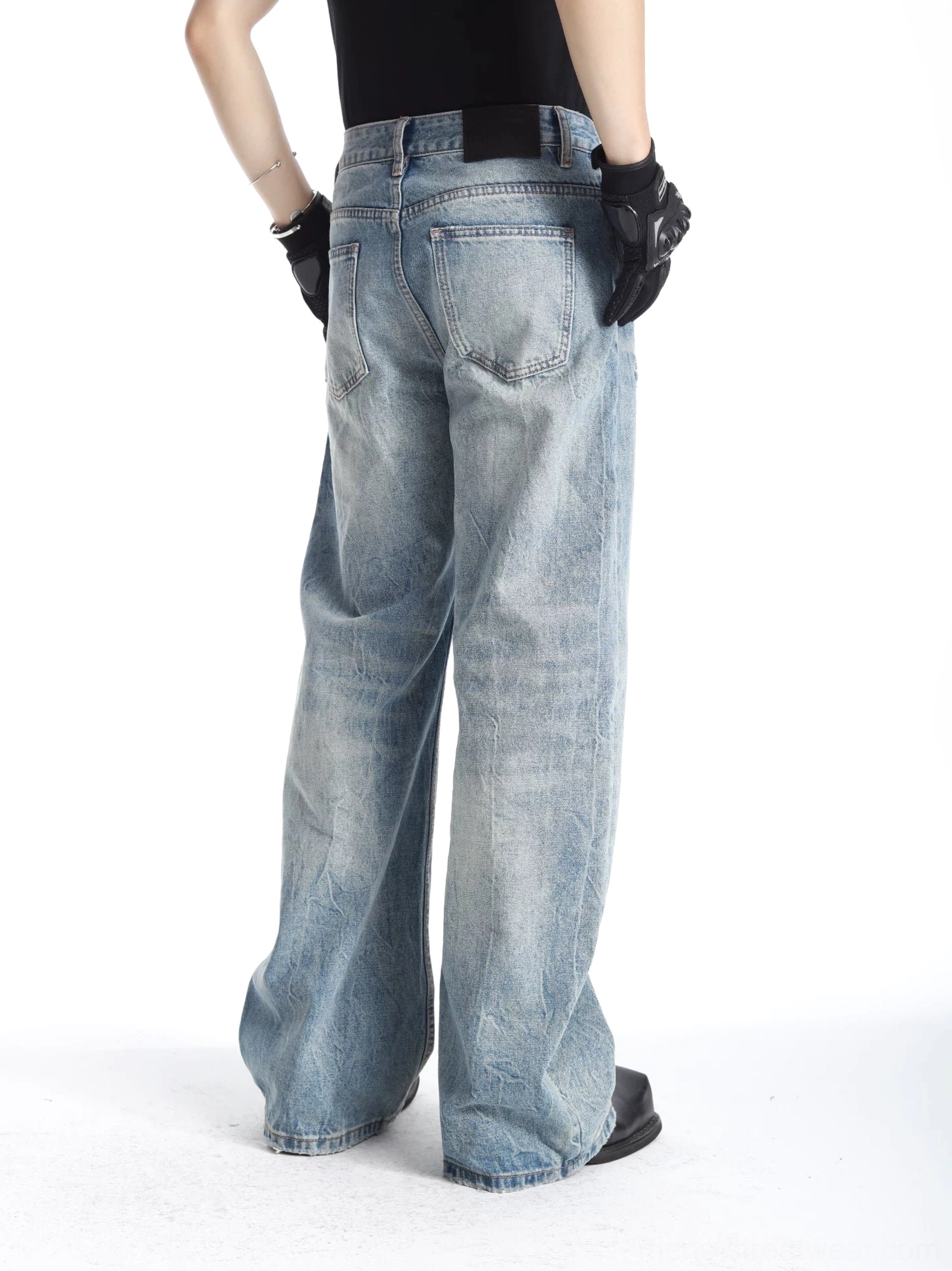 Men's light blue vintage wash barrel-leg jeans rear view showing classic back pockets and wide denim silhouette
