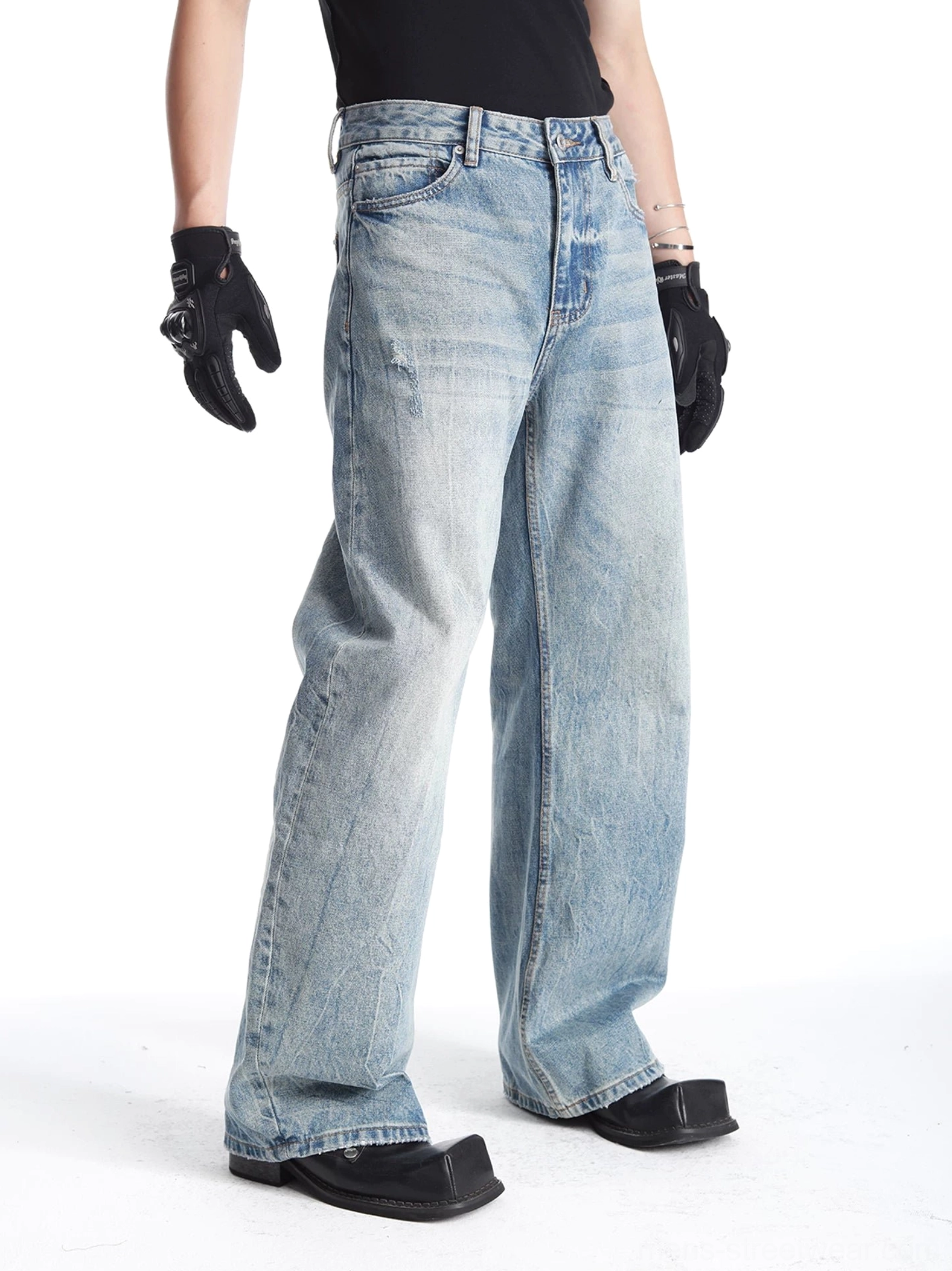 Men's light blue vintage washed wide-leg denim jeans three-quarter side view showing relaxed barrel-leg fit