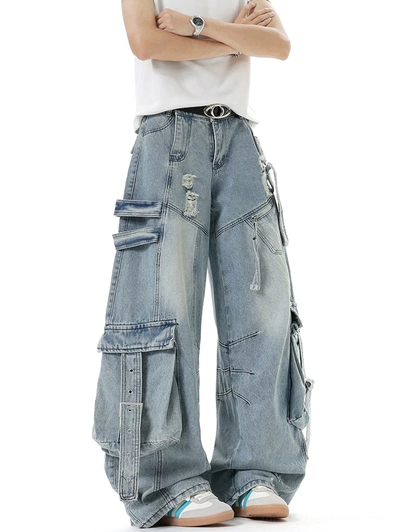 Light blue washed distressed cargo jeans with oversized baggy fit, strap cargo pockets, ripped accents, and casual sneaker styling
