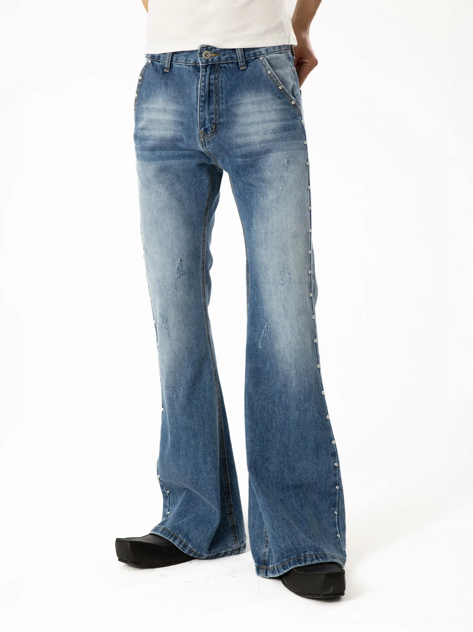 Front and rear angle view of light blue washed studded flare denim with subtle distressing, side rivet trim, and wide bell-bottom legs