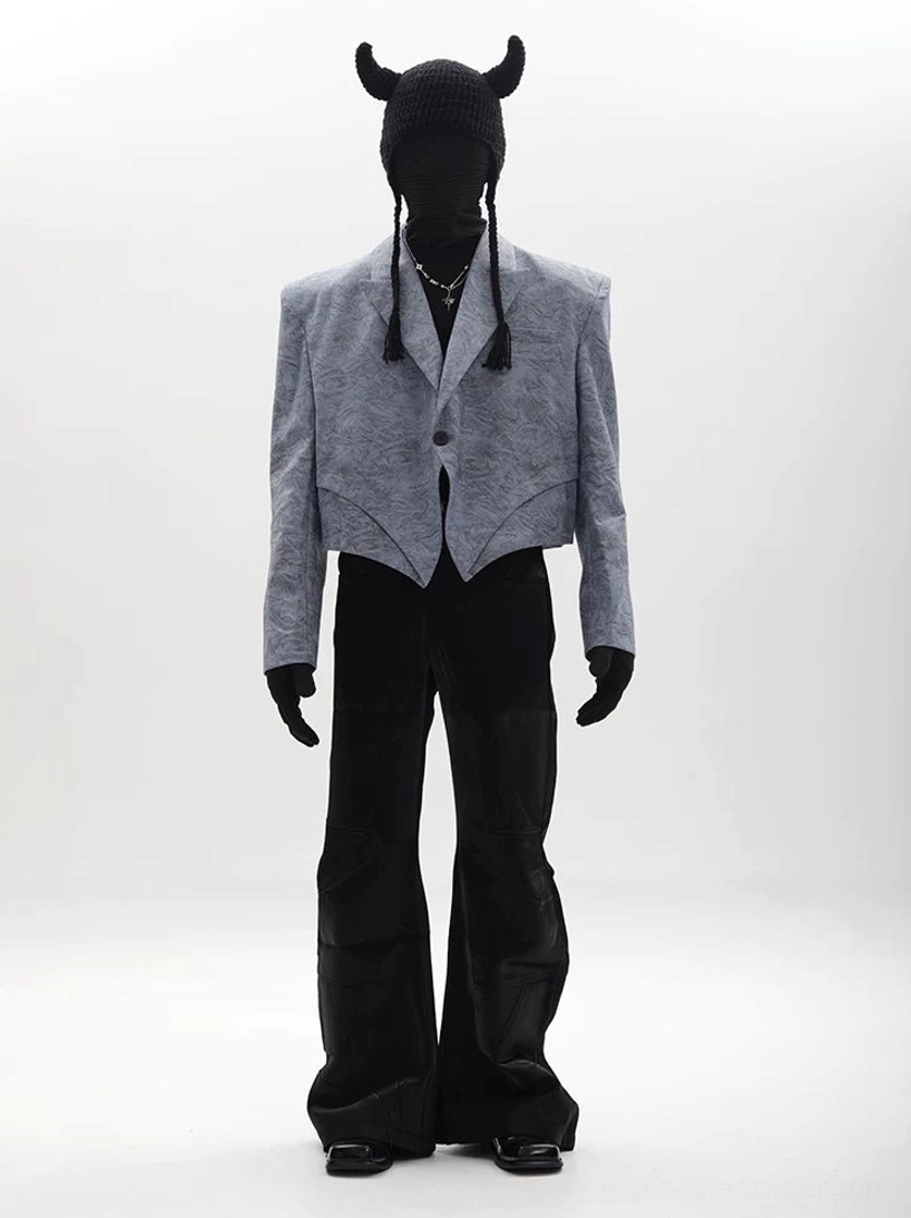 Light gray asymmetric cropped blazer with sharp cropped pointed hem styled with black wide leg leather pants
