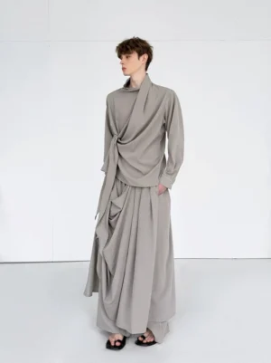 Front view of light gray draped layered wide leg skirted pants in an avant garde streetwear outfit
