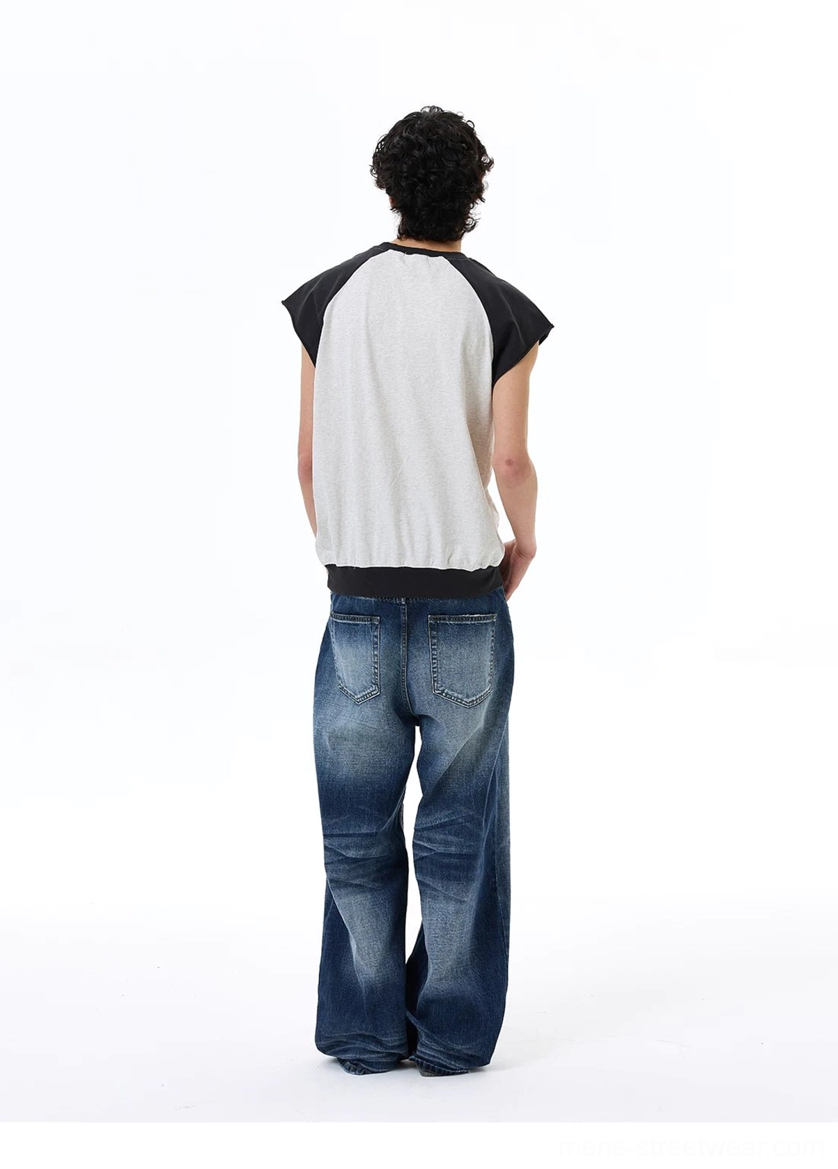 Back view of light gray Find My Soul raglan streetwear tee with black sleeves and medium wash baggy jeans