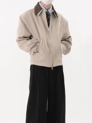 Light gray Korean contrast collar cropped zip blouson jacket worn with shirt tie and wide leg black trousers front three quarter view