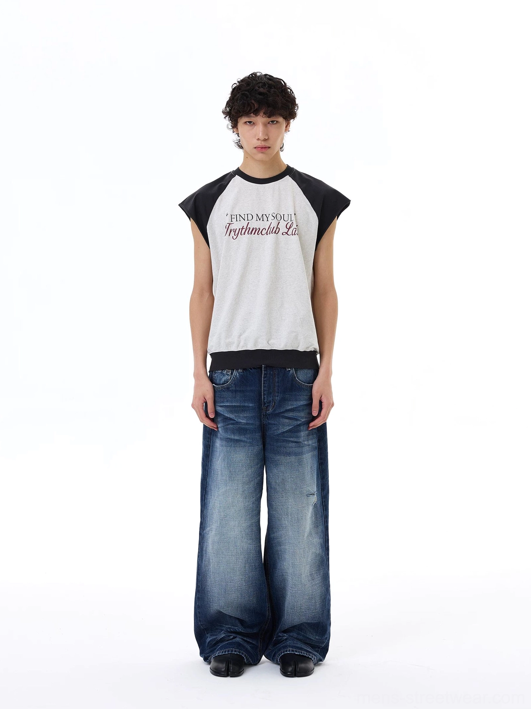 Light gray Korean streetwear raglan tee with black cap sleeves and front slogan graphic styled with baggy jeans