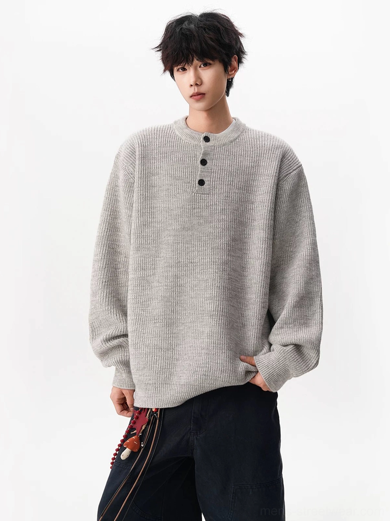 Light gray oversized waffle knit Henley sweater with drop shoulders and wide sleeves styled with black wide-leg cargo pants