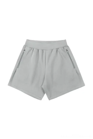 Light gray relaxed cotton blend sweat shorts with ribbed elastic waistband, angled zip pockets, and loose Korean streetwear fit on a white background
