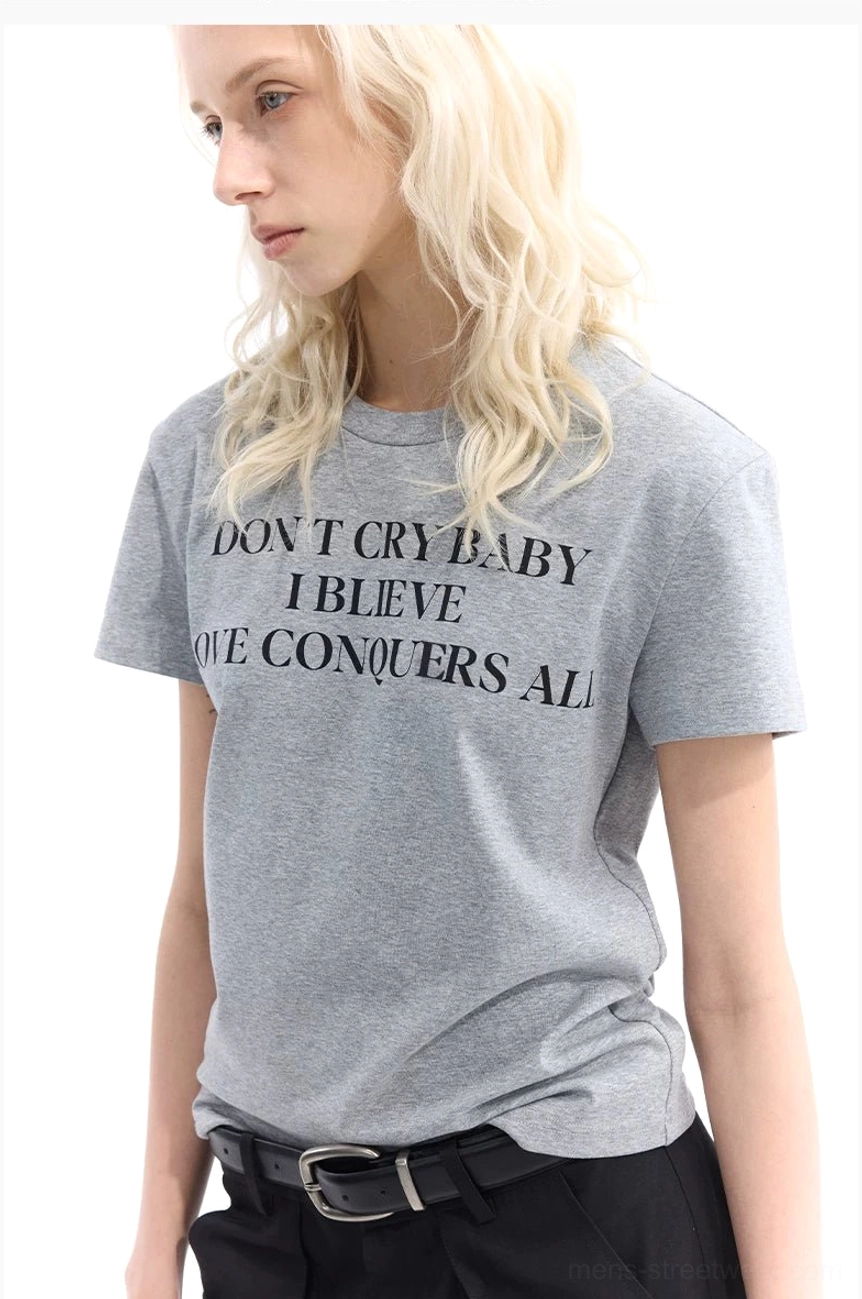 Light gray slim-fit slogan T-shirt shown from the side with centered black streetwear graphic