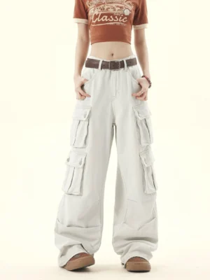 Light gray washed denim cargo pants shown from the front with layered thigh pockets and wide-leg silhouette