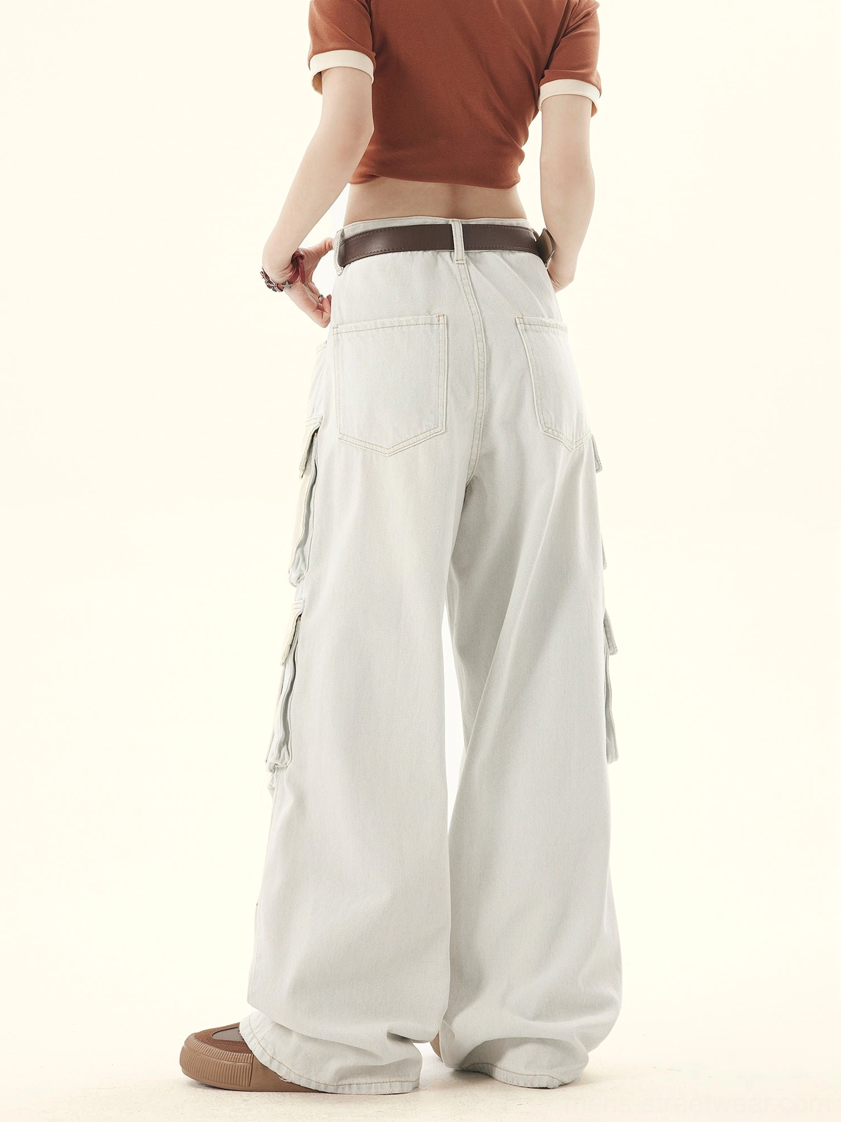 Full back view of light-gray washed wide-leg denim pants with rear patch pockets and relaxed fit