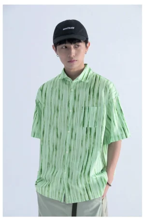 Light green abstract tie dye vertical stripe streetwear shirt with button front chest pocket and relaxed casual fit