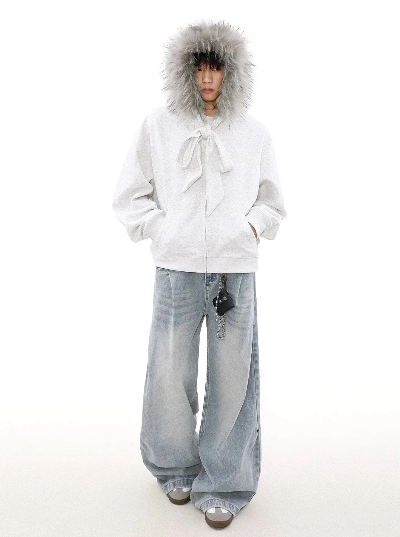 Light grey faux fur trim zip-up hoodie worn with hood up in a wide-leg denim streetwear outfit