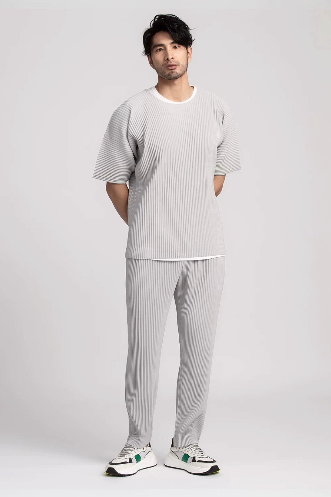 Front view of a light grey men's pleated tee and straight-leg trouser outfit with relaxed Seoul styling