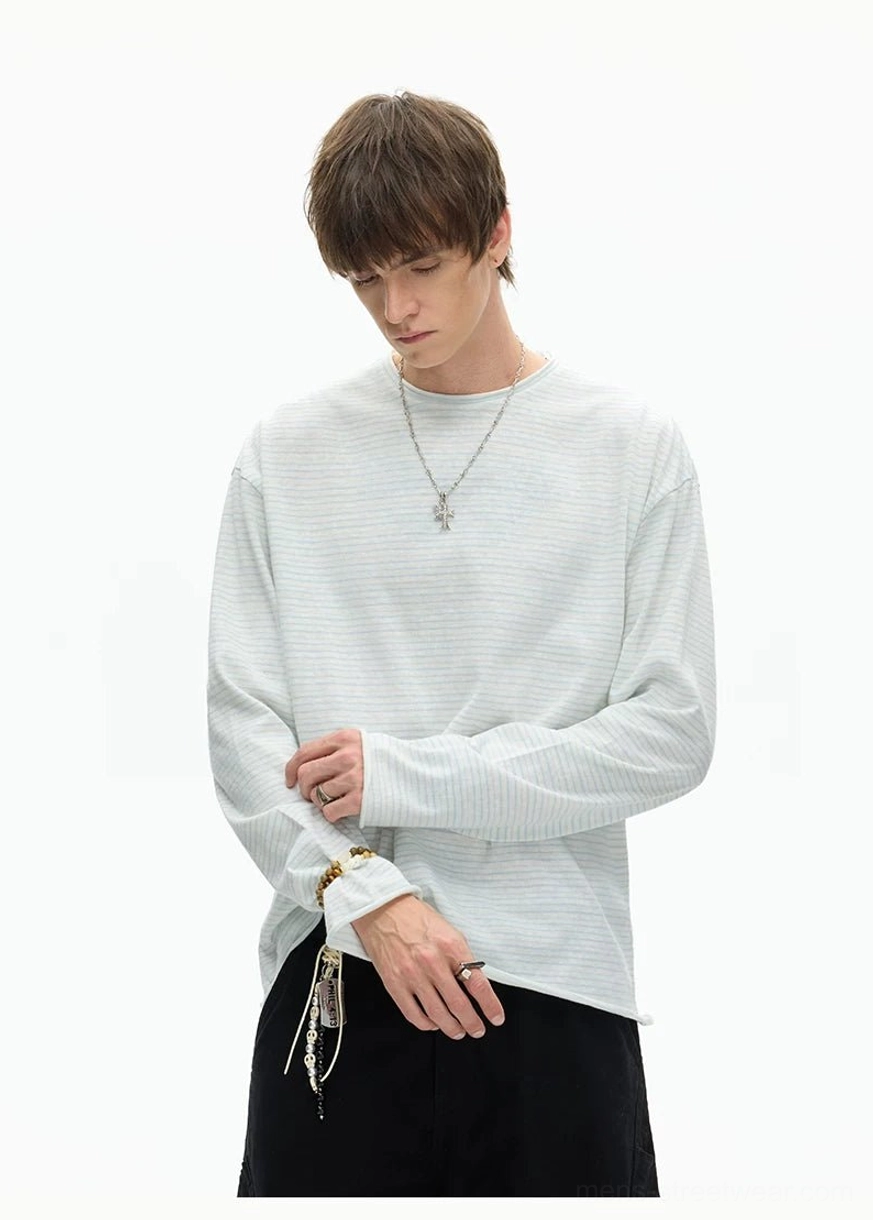 Light grey oversized long sleeve crew neck tee with rolled cuffs and pendant necklace for layered Seoul streetwear styling