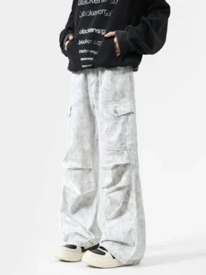 Light grey tie-dye wash wide-leg cargo pants with relaxed slouch fit, utility flap pockets, and oversized streetwear styling
