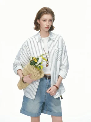 Light khaki oversized vertical stripe shirt shown in a full front view with classic collar, chest pocket, white tee, and denim shorts