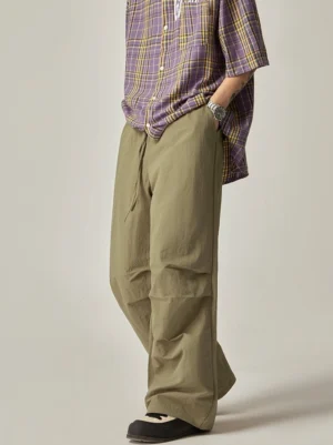 Light khaki loose cargo pants with adjustable drawstring waist, wide-leg silhouette and subtle front creases styled for modern Asian streetwear