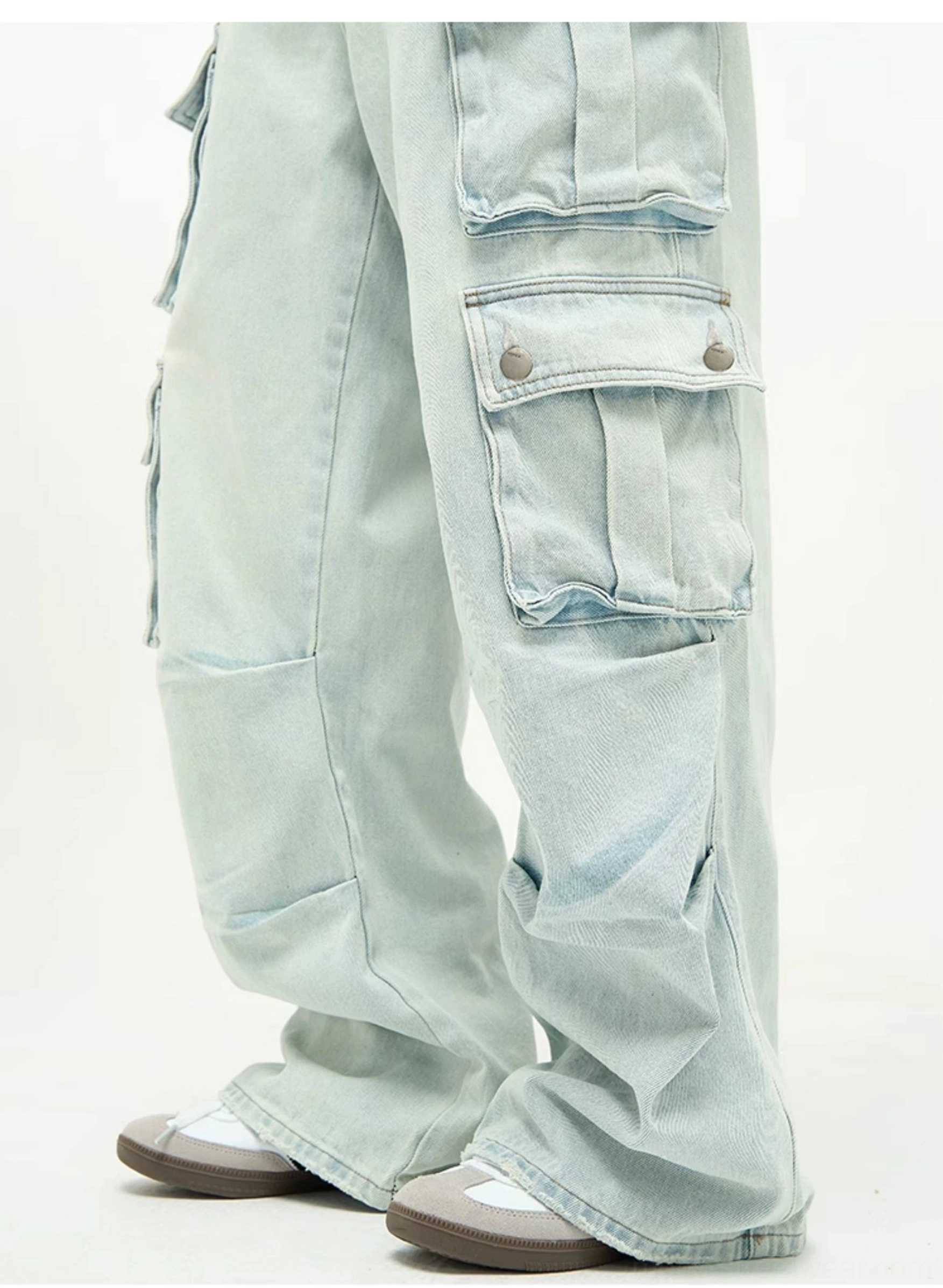 Light wash baggy cargo jeans product image highlighting the extra-wide leg silhouette, oversized utility pockets, and faded blue streetwear denim