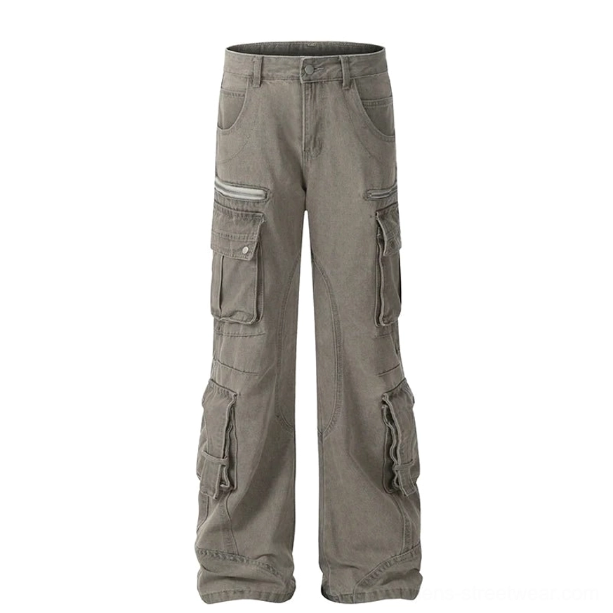 Flat lay of light washed grey wide-leg cargo jeans with faded denim texture, multiple cargo pockets, and zipper details