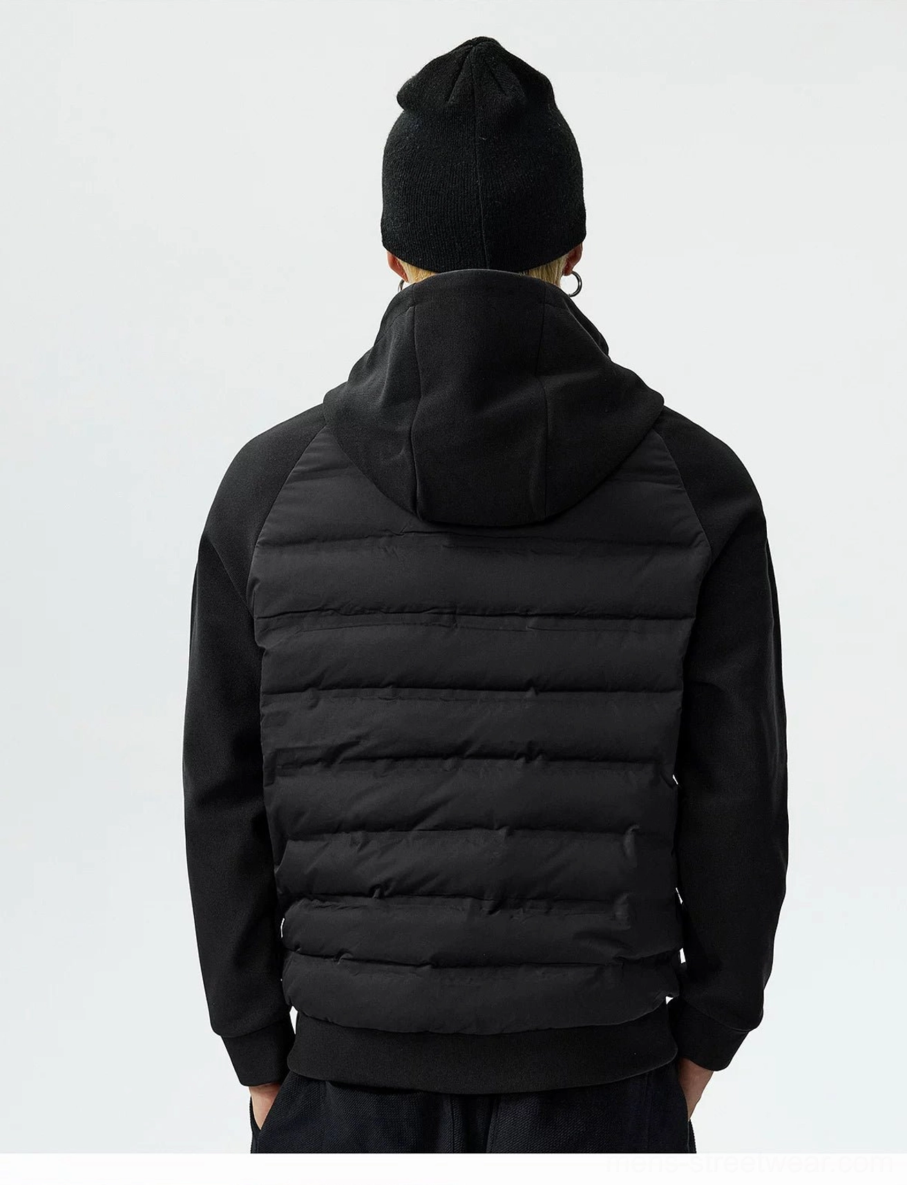 Black hybrid hooded goose down jacket rear studio view showing attached hood quilted back and flexible raglan sleeves
