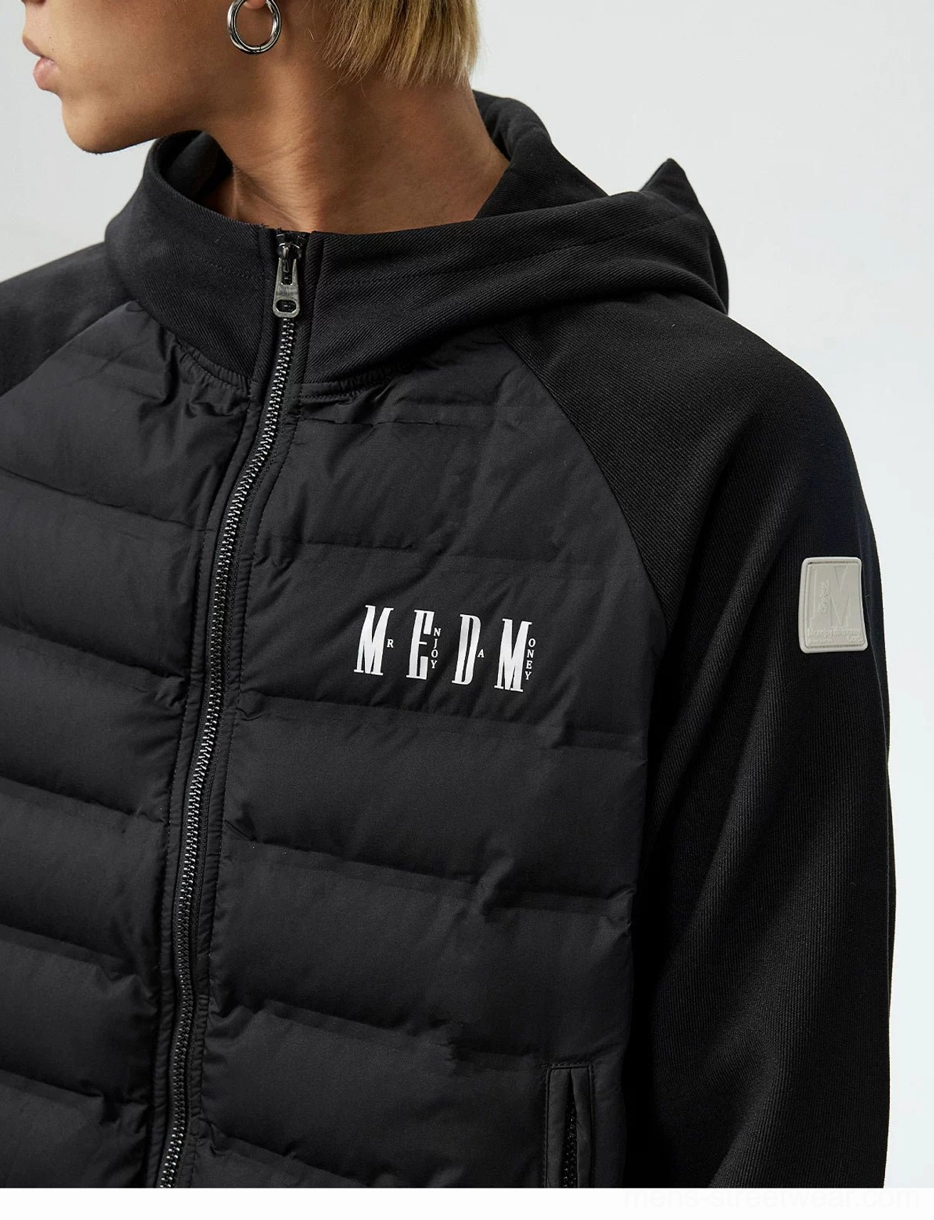 Black lightweight hybrid hooded goose down jacket close-up showing quilted fabric front zipper and chest graphic detail